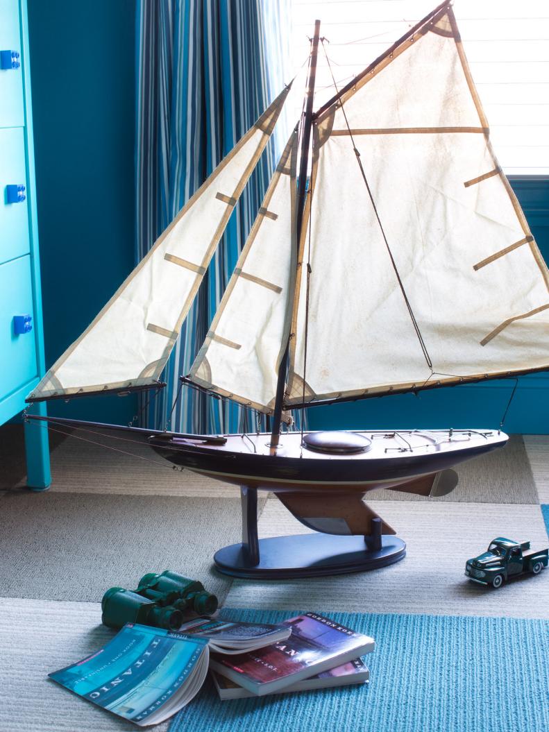 Model Sailboat on Floor With Books & Toy Truck