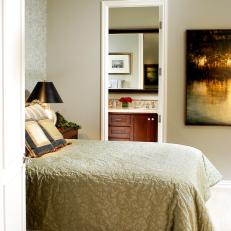 Neutral Traditional Bedroom With Patterned Comforter and Bathroom