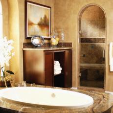 Stone-Surround Soaking Tub in Mediterranean-Inspired Bathroom