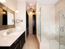 Bathroom With Black Cabinets, White Counters and Spacious Glass Shower