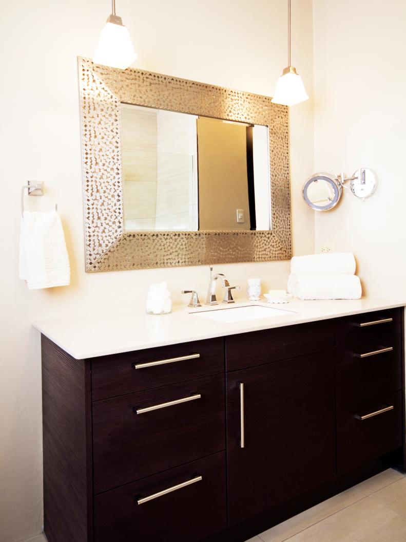 White Bathroom With Metallic Framed Mirror