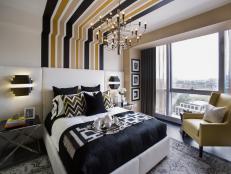 Bedroom With Black and Gold Striped Wall and Black and White Bedding