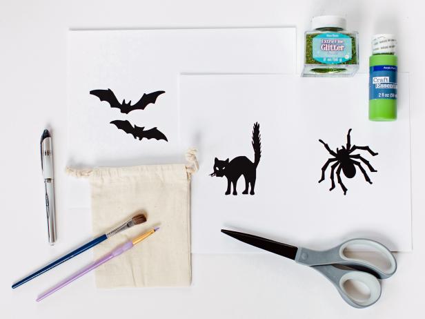 Gather material needed and draw Halloween-themed objects onto standard printer paper or find patterns in old magazines or online. Using scissors, carefully cut around design's outside edge to create a template.