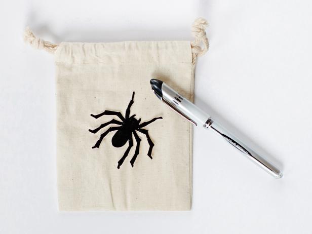 Using scissors, cut carefully around design's outside edge to create a pattern. Lay pattern on muslin bag, and using a pen or pencil, carefully trace around outside.