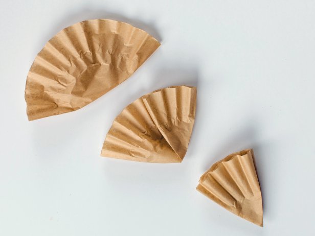 Fold each coffee filter into a pie-slice shape by folding it first in half, then into thirds
