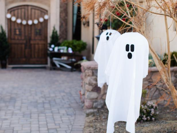 Fabric ghosts hanging from trees