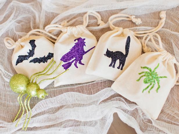Plain fabric bags are transformed into kid-pleasing Halloween party favors with paint and glitter.