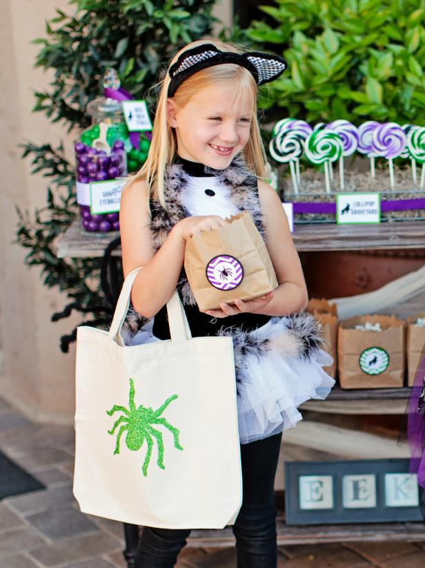 Get kids ready for trick-or-treating with a custom-painted and glittered Halloween tote bag.