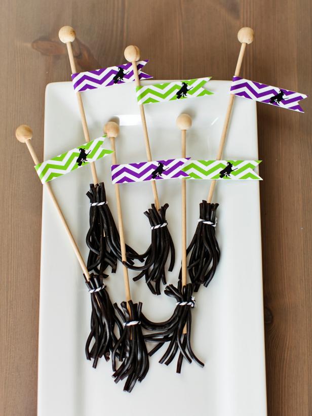 Cut licorice ropes into several short strips, and then place around rock candy stick. Tie at the top with a small piece of twine. Add a flag to the top, and you have a cute homemade Halloween treat, perfect for witches!