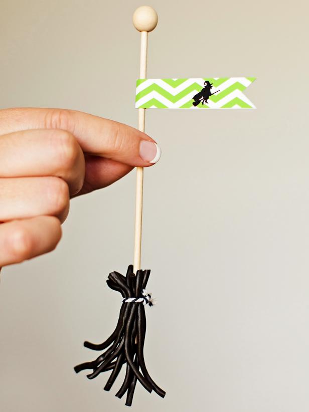 Cut licorice ropes into several short strips, place around rock candy stick and then tie at the top with a small piece of twine. Print flag template onto card stock then then cut out designs and glue a flag to the top of each broom for a cute homemade Halloween treat.
