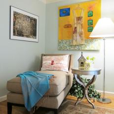 Bedroom Reading Nook With Neutral Chaise and Colorful Wall Art