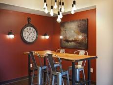Red Dining Room With Rustic Wood Table and Industrial Metal Barstools