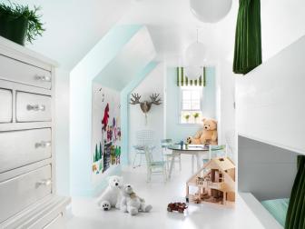 White bedroom with dresser and green bed curtains