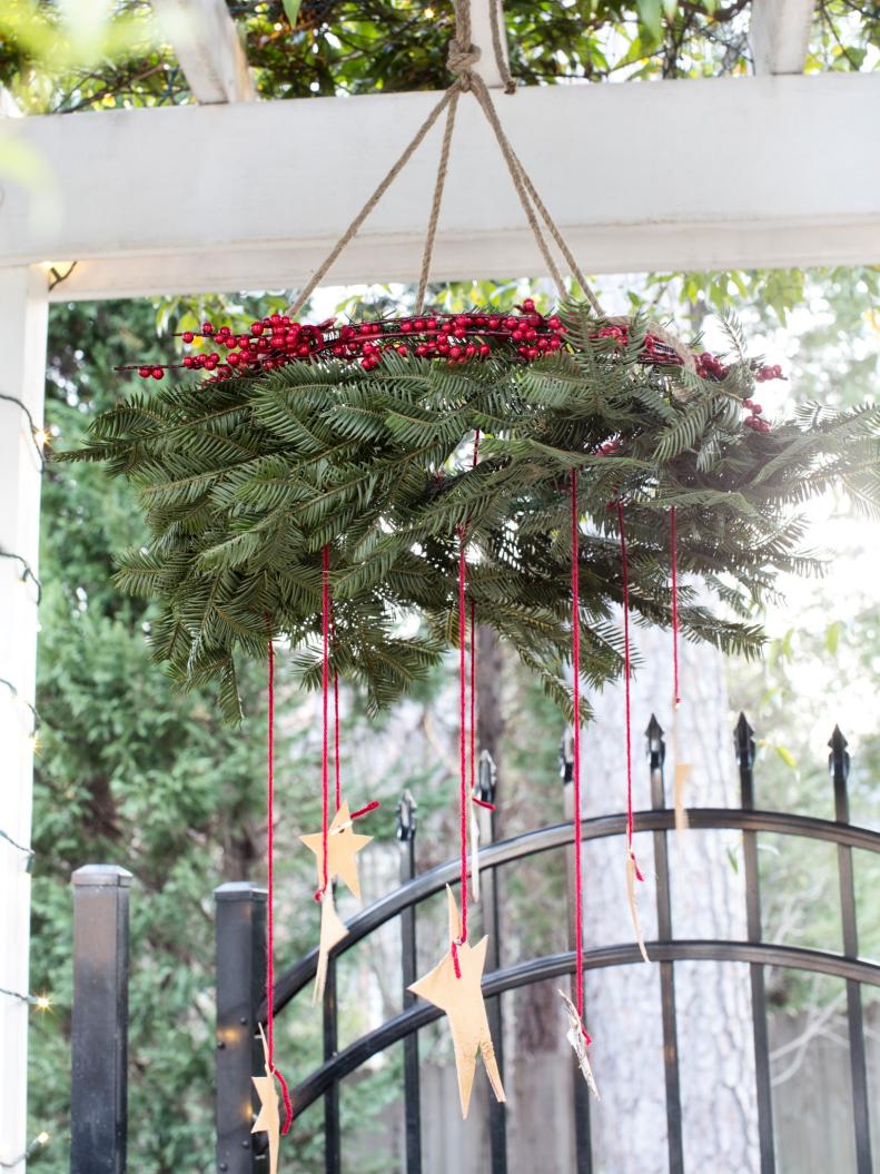 Wreath Suspended From Pergola With Dangling Stars