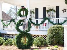 Snowman Created From Stacked Wreaths in Front Yard