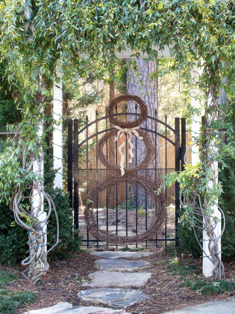 Three Wreaths Form Snowman on Iron Gate