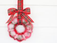 Ice Wreath Hands From Plaid Ribbon on White Backdrop