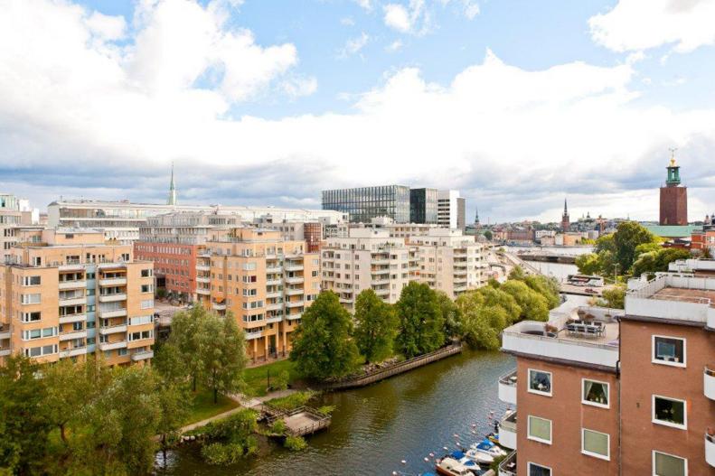 Rooftop view of Stockholm, Sweden, with apartment buildings and canal.