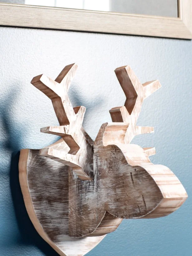 Sculptural objects, like this moose, need a bit more breathing room than framed objects. The extra spacing will help to visually frame the sculptural object, highlighting its shape.