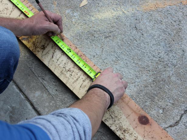 Once proper dimensions are taken, mark each of the two discarded planks to the proper size of side openings with pencil or marker.Referring to marks, cut discarded planks into end caps using saw.