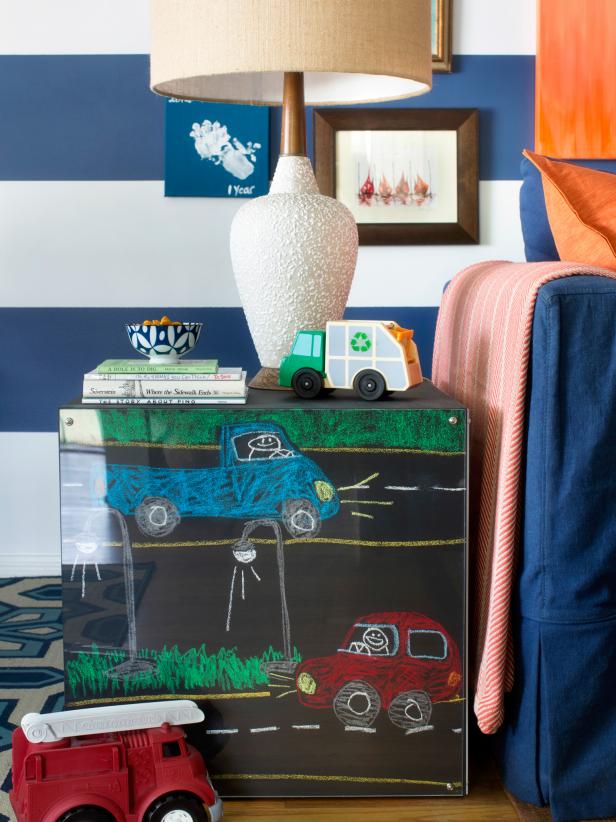 Colored chalk used to create kid-centric drawings gives the chalkboard side tables a more youthful look and provides a centerpiece for this blue and white living room.