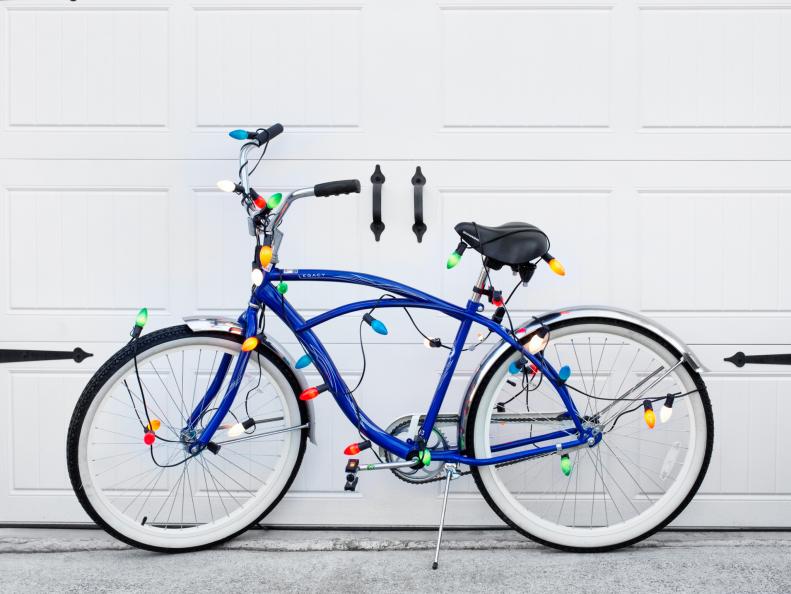 Vintage-inspired bicycle wrapped in Christmas string lights