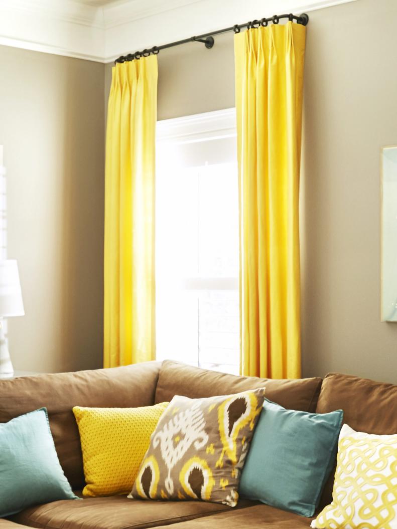 Silk yellow curtains in neutral living room