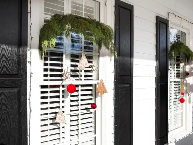 HGTV designer Dan Faires dresses up exterior windows for the holidays with bundled tree cuttings and all-natural, easy-to-make ornaments.