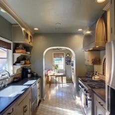 Luxurious Galley Kitchen in Gray With Arched Doorway