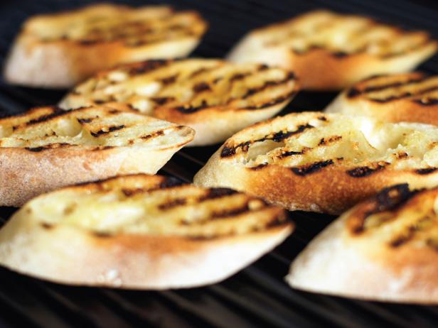 Grill the baguette slice, oil-side down, on a grill pan until toasted.