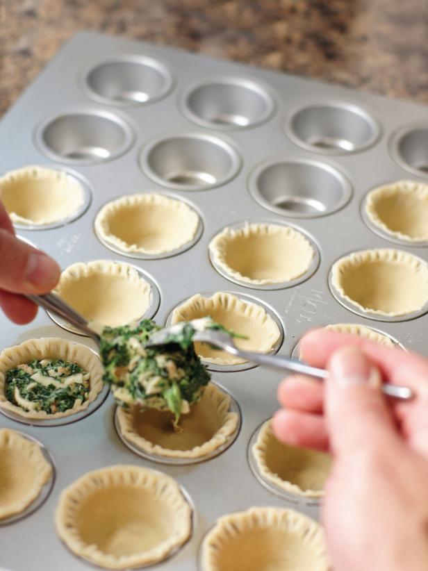 Press each pie crust circle into the mini muffin pan, and use a fork to flute the edges at the top. Fill each mini pie with the quiche filling to just below the top of the pie crust. Bake for 20-25 minutes.