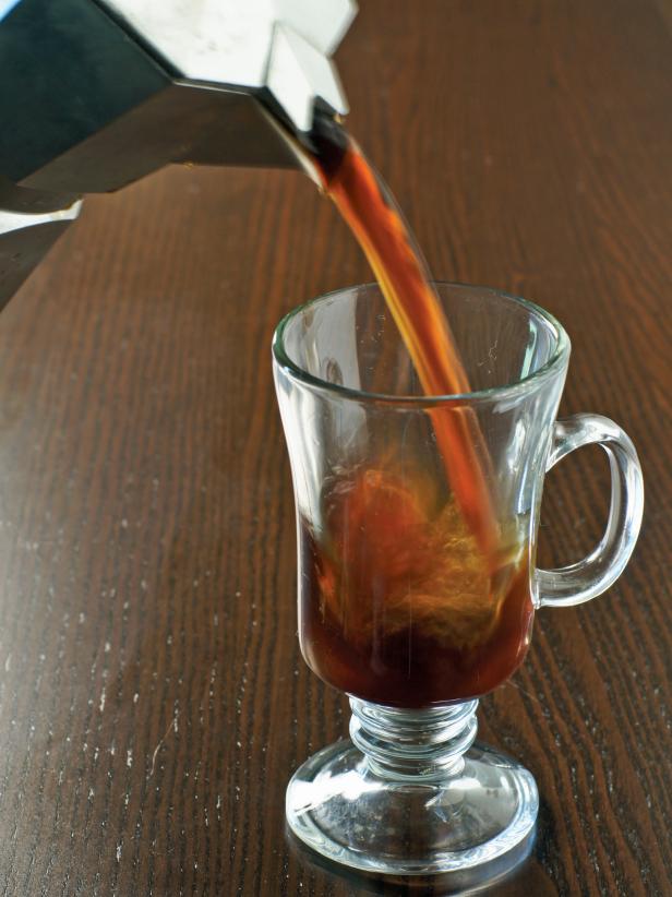 The first step is to brew coffee and pour it into a heatproof mug or glass. Make sure you use a quality roast coffee.