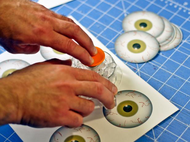 Print eyeball template (http://hgtv.sndimg.com/HGTV/2013/07/19/original_Sam-Henderson-Snake-Eyes-template.pdf) onto six sheets of label paper. Cut out design using scissors or a circle cutter.