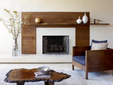 White Fireplace With Brown Wood Surround, Floating Mantel & Wood Chair