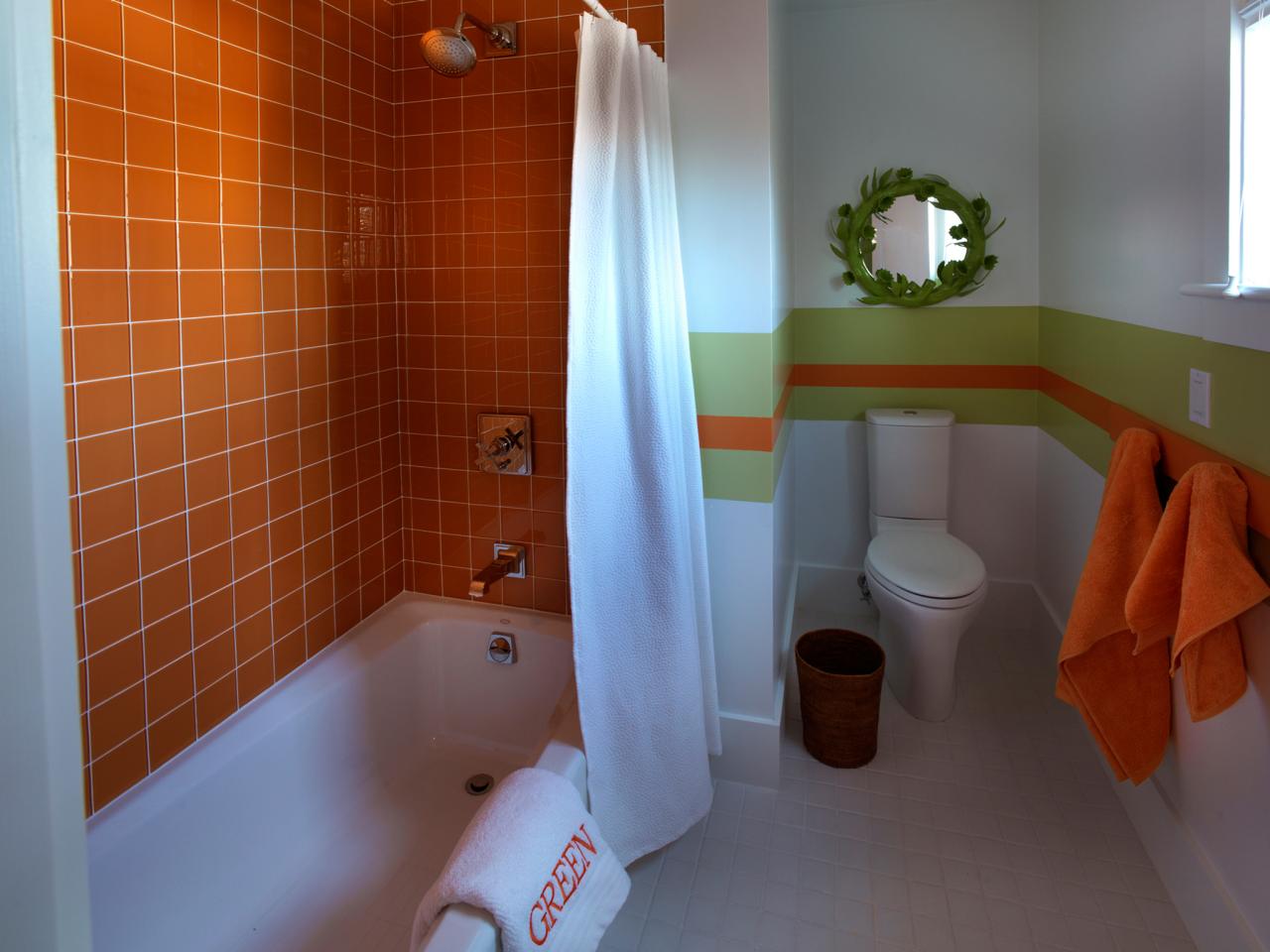 White Kid's Bathroom With Orange Tile Shower | HGTV