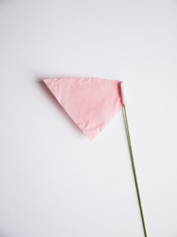 Cut a small square of crepe paper and fold in half to get a triangle. Fold the triangle around a floral wire tip.