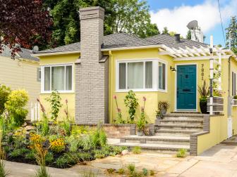 Yellow Home With Gray Chimney, White Pergola, Blue Front Door