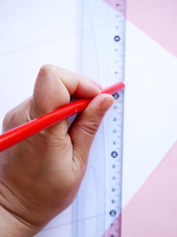 Measure the center of the paper width and the paper height and mark them with dots. Join the dots to draw a diamond shape on the back of the paper.