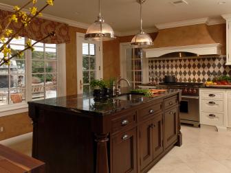 Traditional Kitchen With Dark Wood Island and Metal Pendant Lights