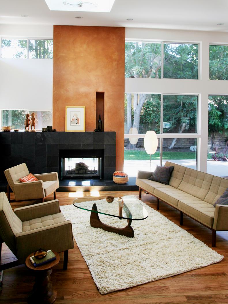 Great room with bronze accent wall, black fireplace. 