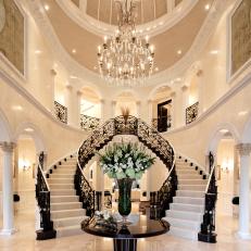 Grand Black and White Entryway With Double Staircase