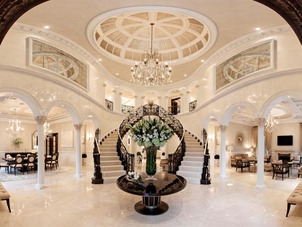 Spacious Black & White Foyer With Detailed Ceiling & Grand Staircase