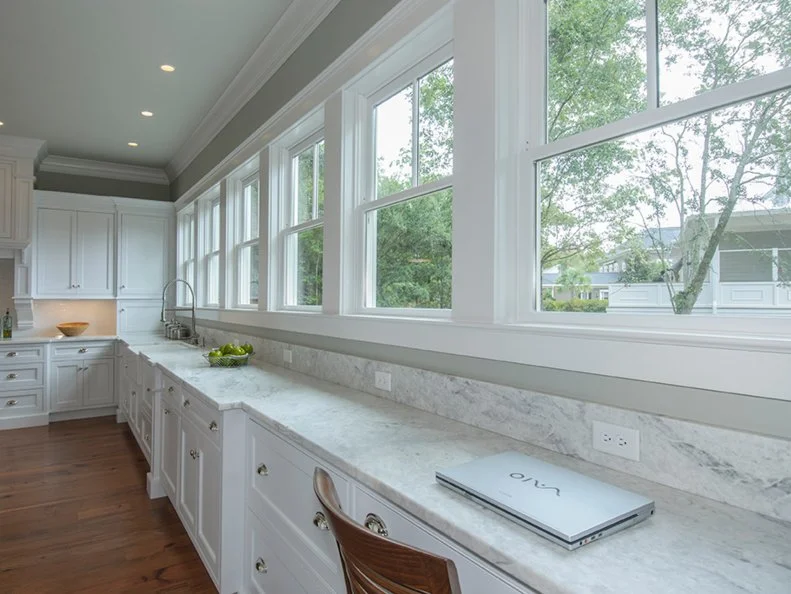 White Transitional Kitchen With Full-Wall Windows and Long Counter Transitional White Kitchen With Extended Counter