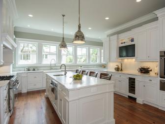 Traditional White Kitchen With Large Center Island and Hardwood Floors