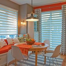 Vibrant and Eclectic Orange and White Dining Area