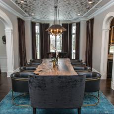 Dramatic Gray Dining Room With Blue Velvet Rug and Brass Pendant Light