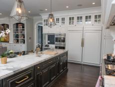 White Kitchen With Black Island Cabinets, White Countertops and Pantry