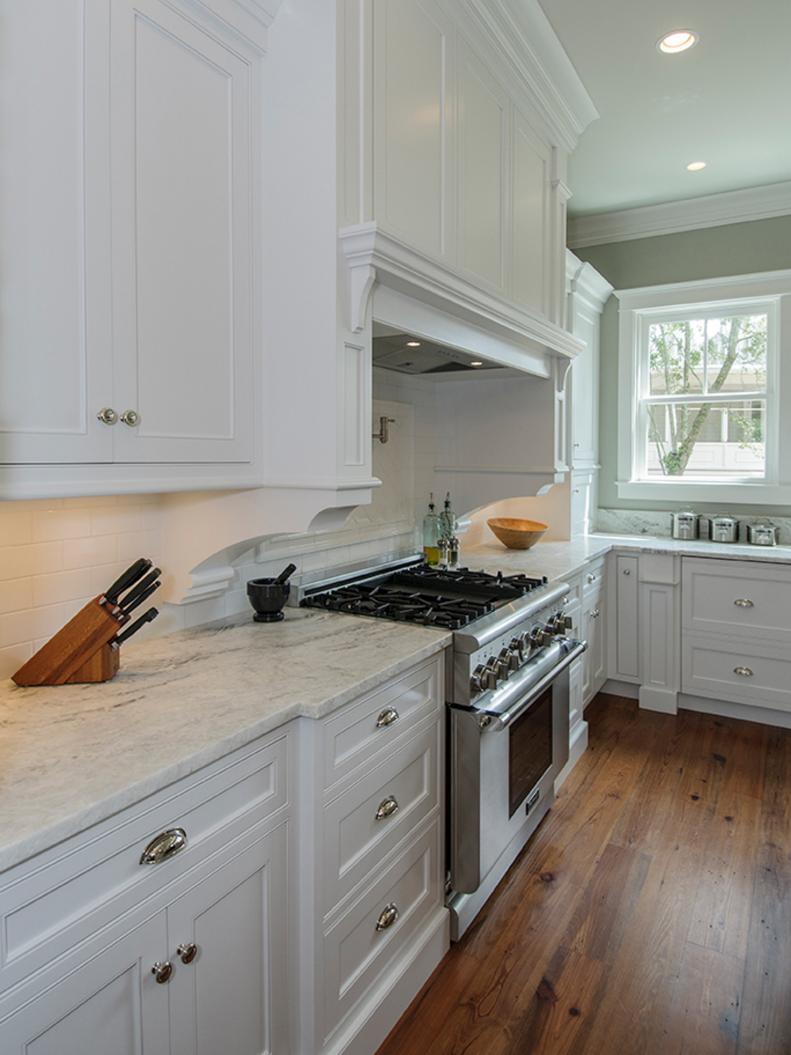 Traditional Kitchen With White Cabinetry and Marble Countertops