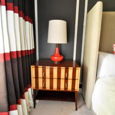 Funky Striped Nightstand With Red Lamp