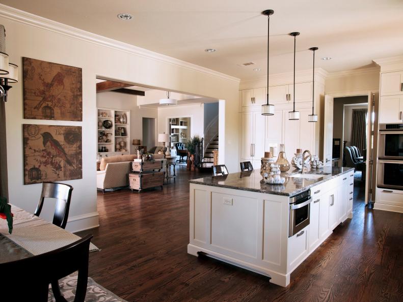 Neutral Kitchen With Large Island, Hardwood Floor & Pendants Lights